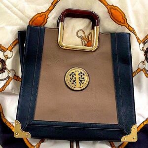 Black and tan tote with gold tone metal trim.  GREAT FOR FALL!  Faux leather